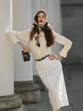 a lady wears a beige mulberry silk shirt with a midi skirt